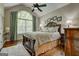 Bright bedroom with large window, hardwood floors, and comfortable seating with a view of the outside at 273 Prominent Loop, Mcdonough, GA 30253