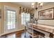 Dining room with hardwood floors, chandelier, decorative painting, and door to the backyard at 273 Prominent Loop, Mcdonough, GA 30253