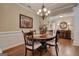 Elegant dining room featuring wainscotting, hardwood floors, and a decorative chandelier at 273 Prominent Loop, Mcdonough, GA 30253