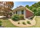 Side exterior view showcasing the property's brick and vinyl siding, complemented by a landscaped garden at 273 Prominent Loop, Mcdonough, GA 30253
