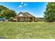 A single-Gathering home with a brick facade, expansive front yard, and a covered porch at 273 Prominent Loop, Mcdonough, GA 30253