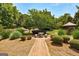 A stone picnic table along a brick walking path and a wooden gazebo in a park-like setting at 273 Prominent Loop, Mcdonough, GA 30253
