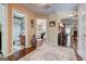 Inviting hallway with hardwood floors leading to bathroom, living room and a cozy seating area at 273 Prominent Loop, Mcdonough, GA 30253