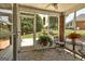 Inviting screened porch with tiled flooring, outdoor seating, and views of the lush backyard at 273 Prominent Loop, Mcdonough, GA 30253