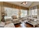 Cozy sunroom featuring a vaulted ceiling, plantation blinds, and comfortable seating arrangements at 273 Prominent Loop, Mcdonough, GA 30253