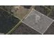 Aerial view of property on Creel Rd shows lot lines and home nestled among mature trees, offering privacy and seclusion at 4950 Creel Rd, Fairburn, GA 30213