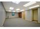 Spacious basement with carpet flooring, ample lighting, and storage shelves at 4950 Creel Rd, Fairburn, GA 30213
