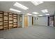 Large basement area with carpet and built-in shelving for ample storage at 4950 Creel Rd, Fairburn, GA 30213