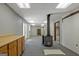 Finished basement area with a wood burning stove, cabinets and ample lighting at 4950 Creel Rd, Fairburn, GA 30213