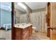 Bathroom boasts vanity, shower/tub, framed mirror, and view to a bedroom at 4950 Creel Rd, Fairburn, GA 30213
