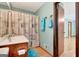 Cozy bathroom offers vanity with storage, patterned shower curtain, and a wood framed doorway at 4950 Creel Rd, Fairburn, GA 30213