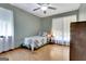 Comfortable bedroom has hardwood floors, bright windows, ceiling fan, and closet at 4950 Creel Rd, Fairburn, GA 30213