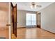Bright bedroom with hardwood floors, ceiling fan, closet, and large window with sheer curtains at 4950 Creel Rd, Fairburn, GA 30213
