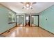 Large bedroom with hardwood floors, windows, mirrored closets, and access to an ensuite bathroom at 4950 Creel Rd, Fairburn, GA 30213