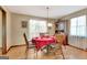 Well-lit dining room with wooden table, chairs, and natural light streaming through the windows at 4950 Creel Rd, Fairburn, GA 30213