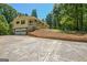 Inviting exterior featuring a yellow home with a two-car garage and a well-maintained front yard at 4950 Creel Rd, Fairburn, GA 30213