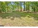 Well maintained yard with mature trees partially obscuring the house in the background at 4950 Creel Rd, Fairburn, GA 30213