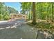 Charming single-story home featuring a welcoming front porch and long driveway surrounded by mature trees at 4950 Creel Rd, Fairburn, GA 30213
