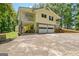 Beautiful home featuring a two-car garage, stone accents, and a well-manicured lawn at 4950 Creel Rd, Fairburn, GA 30213