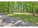 Long driveway and trees surrounding the house, creating a private, secluded atmosphere at 4950 Creel Rd, Fairburn, GA 30213
