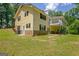 Rear exterior featuring a deck and patio with a view of the lush yard at 4950 Creel Rd, Fairburn, GA 30213