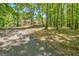Single story home among a forest-like setting with a long, winding driveway at 4950 Creel Rd, Fairburn, GA 30213