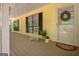 Charming front porch featuring a rocking chair, wreath on the door, and ample natural light at 4950 Creel Rd, Fairburn, GA 30213