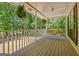 Inviting front porch with porch swing, hanging plants, and views of the surrounding nature at 4950 Creel Rd, Fairburn, GA 30213