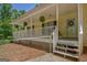 Inviting front porch with white railing, hanging plants, and steps leading to the front door at 4950 Creel Rd, Fairburn, GA 30213