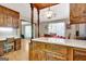 Eat-in kitchen and breakfast area with wooden cabinets, hardwood floors, and view to dining room at 4950 Creel Rd, Fairburn, GA 30213