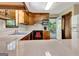 Kitchen featuring wood cabinetry, stainless steel sink, and a view of the exterior deck through the door at 4950 Creel Rd, Fairburn, GA 30213