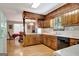 Bright kitchen featuring wood cabinetry and white countertops, open to the dining area at 4950 Creel Rd, Fairburn, GA 30213