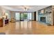 Spacious living room with hardwood floors, fireplace, and large windows for natural light at 4950 Creel Rd, Fairburn, GA 30213