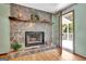 Stone fireplace with a wood mantel sits in the living room near a door that leads outside at 4950 Creel Rd, Fairburn, GA 30213