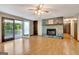 Spacious living room featuring a stone fireplace, a ceiling fan, and sliding doors to the deck at 4950 Creel Rd, Fairburn, GA 30213