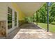 Covered patio featuring stone accents and a view of the backyard at 4950 Creel Rd, Fairburn, GA 30213