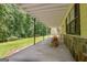 Spacious covered patio with stone accents, perfect for outdoor entertaining or relaxation at 4950 Creel Rd, Fairburn, GA 30213