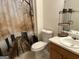 Cozy bathroom with a decorative shower curtain and storage shelves at 3505 Saddle Creek Ln, Ellenwood, GA 30294