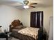 Bedroom featuring a wooden bed frame, a ceiling fan, and large window at 3505 Saddle Creek Ln, Ellenwood, GA 30294