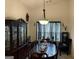 Elegant dining room featuring a large table with seating for eight, chandelier, and dark wood accents at 3505 Saddle Creek Ln, Ellenwood, GA 30294