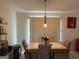 Cozy dining area with a tile-top table, upholstered chairs, and a pendant light fixture at 3505 Saddle Creek Ln, Ellenwood, GA 30294