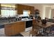 Well-lit kitchen featuring modern appliances and a dining table with wooden stools at 3505 Saddle Creek Ln, Ellenwood, GA 30294