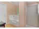 This airy bathroom has both a shower and a tub with built-in jets at 5865 El Segundo Way, Atlanta, GA 30349