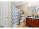 This cozy bathroom features a convenient shower curtain and practical storage shelves at 5865 El Segundo Way, Atlanta, GA 30349