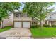 Inviting two-story home featuring a two-car garage and well-maintained front yard at 5865 El Segundo Way, Atlanta, GA 30349