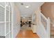 View of foyer with staircase and view into living room with fireplace at 5865 El Segundo Way, Atlanta, GA 30349
