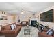 Cozy living room with a ceiling fan, fireplace, and plush furniture at 5865 El Segundo Way, Atlanta, GA 30349