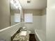 Clean bathroom featuring a granite vanity, ample lighting, and a shower-tub combination at 2896 Hogan Rd, East Point, GA 30344