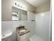 Bathroom featuring a granite sink and shower with white tiled walls at 2896 Hogan Rd, East Point, GA 30344