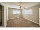 A cozy bedroom with a ceiling fan and two windows with mini blinds at 2896 Hogan Rd, East Point, GA 30344